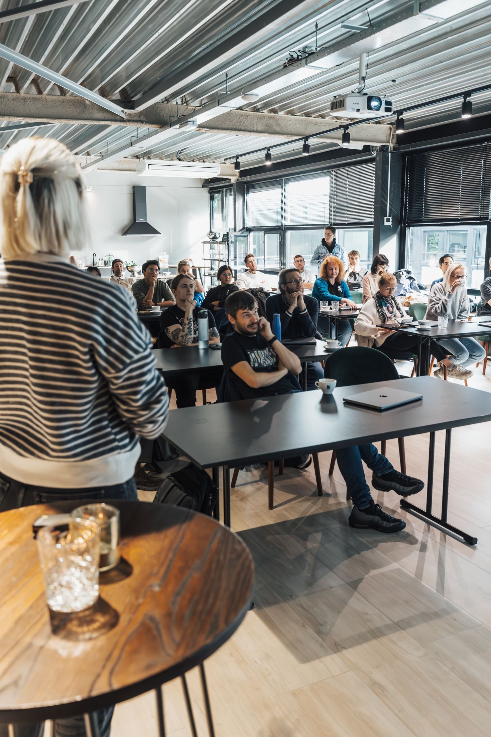 A modern classroom setting with diverse adults engaging in an educational presentation