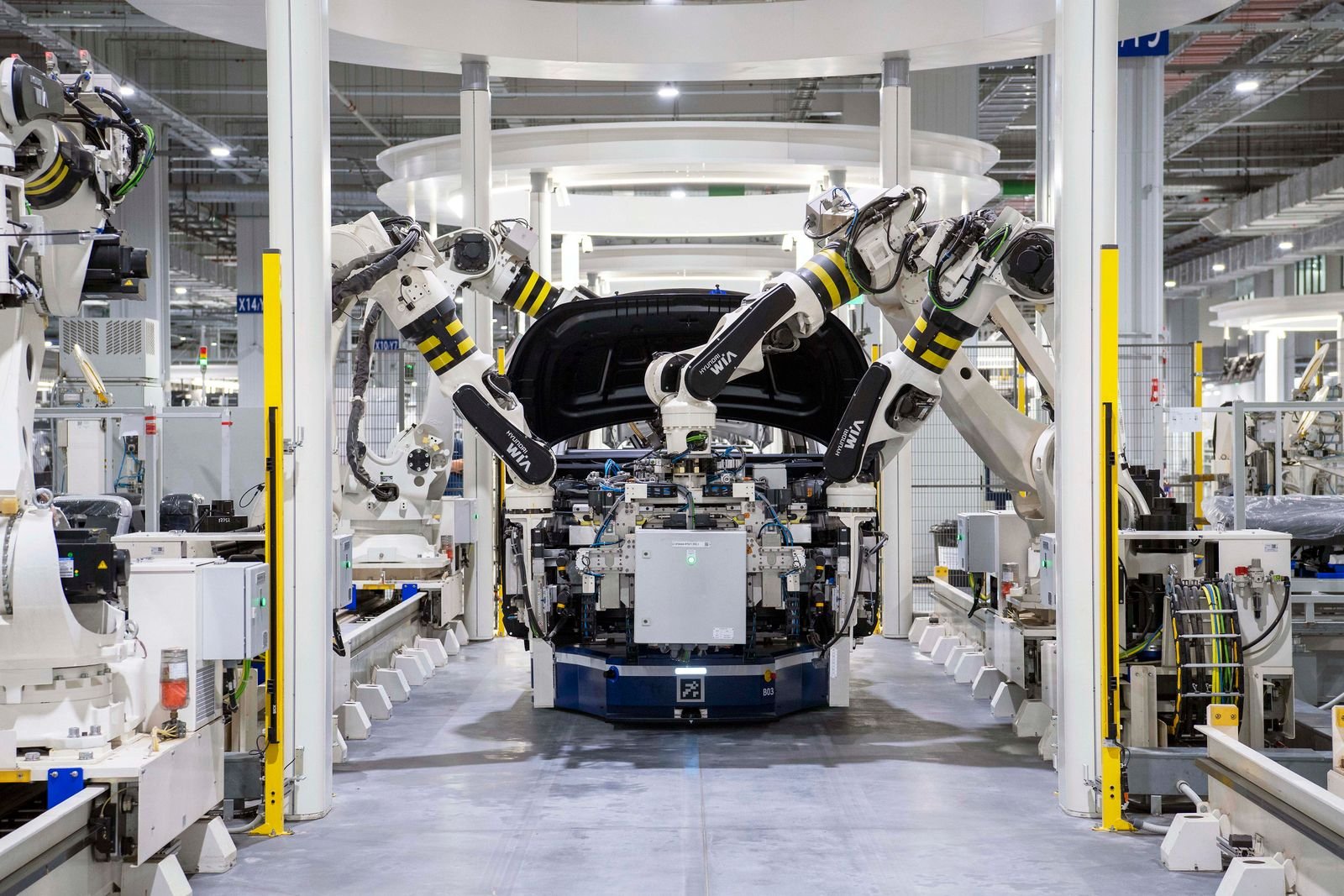 High-tech robots assembling a car in a modern factory setting, showcasing automation