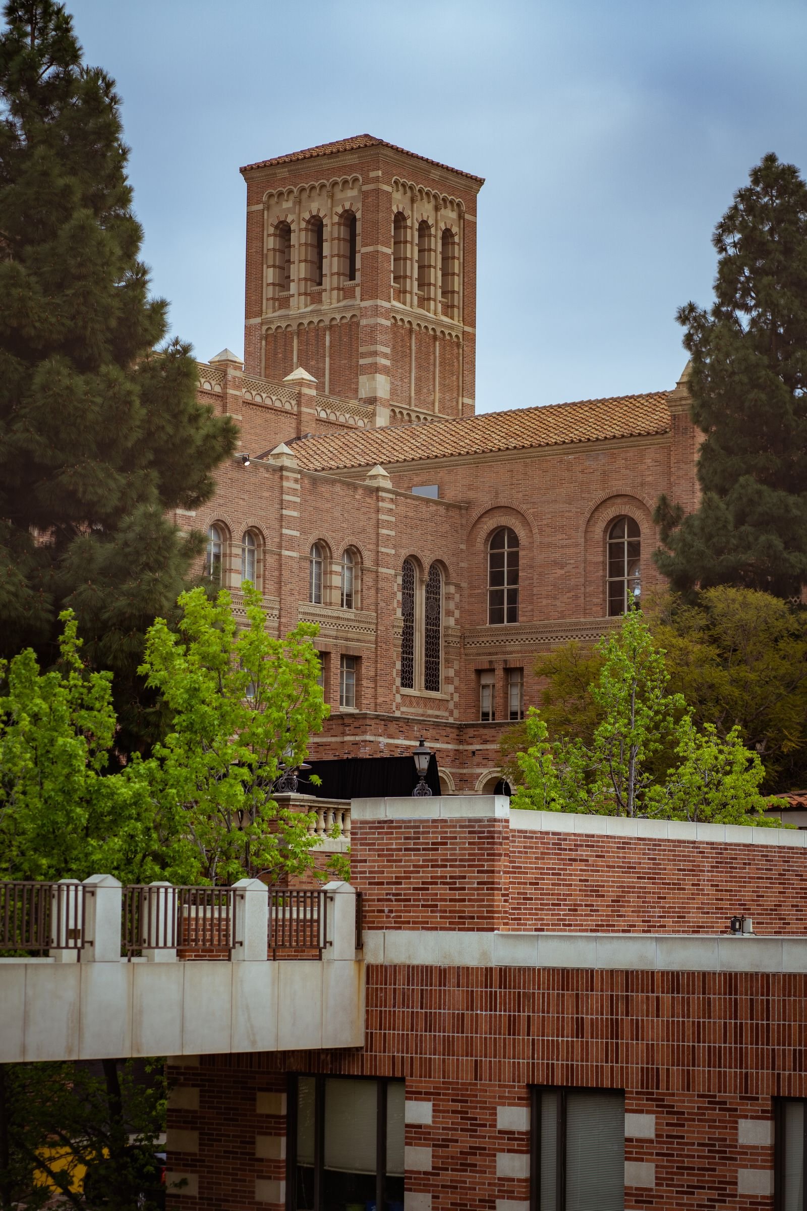 Historic brick building at the University of California, Los Angeles surrounded by trees