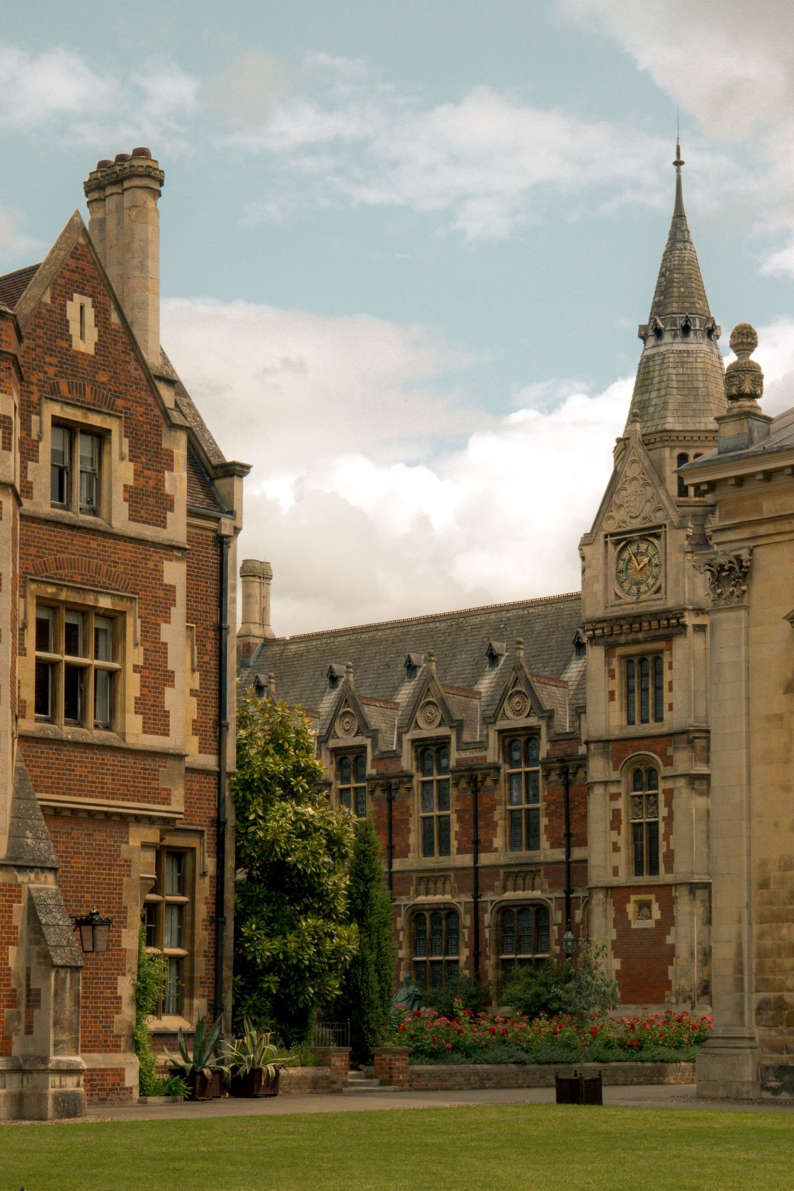 Gothic-style architecture with ornate details and lush garden at a historic university campus