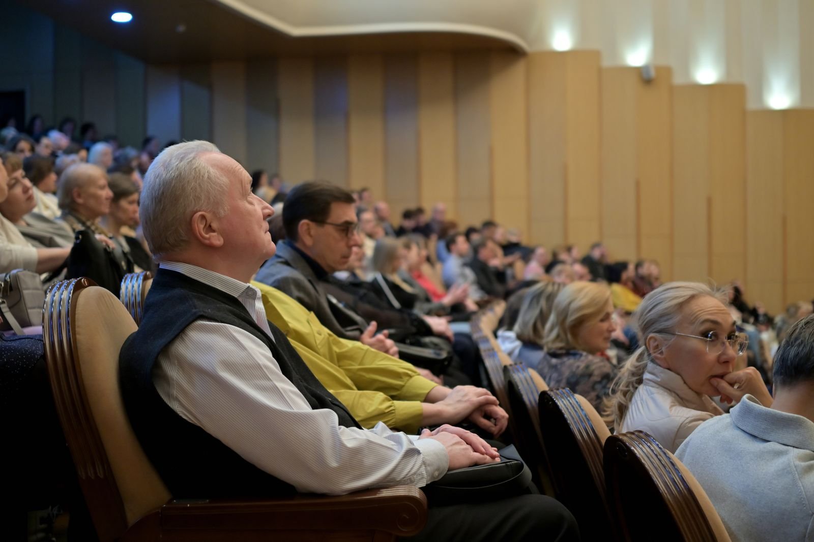 A diverse audience attentively listening during a conference in an auditorium