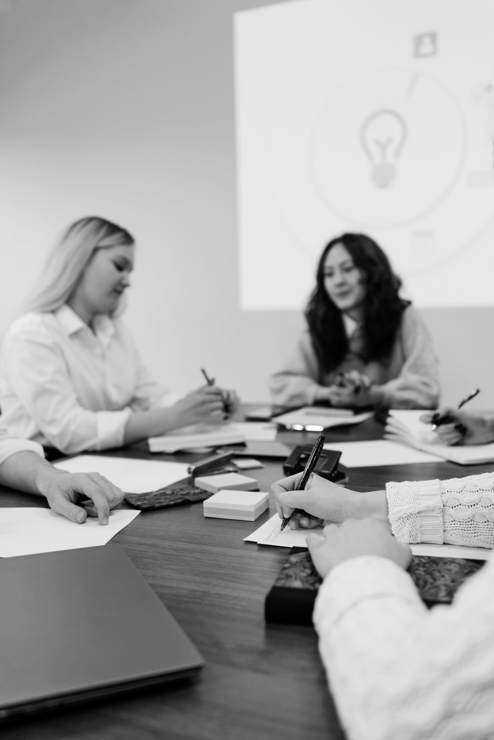 A group of colleagues engaged in a brainstorming session around a table, planning strategies